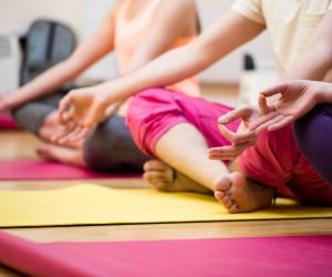 Group of people sitting in lotus position Group of people sitting in lotus position in the fitness studio